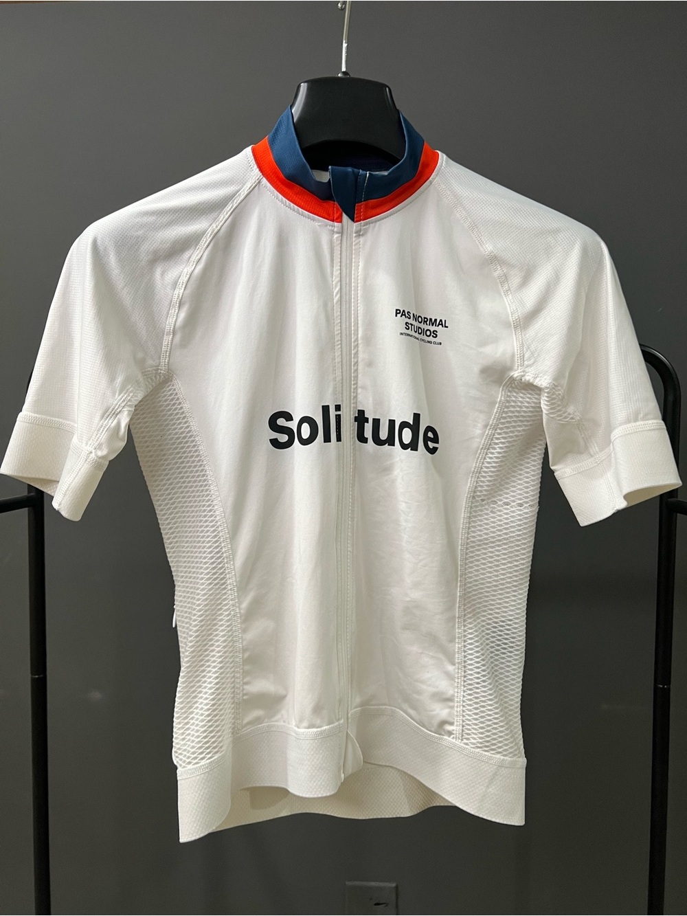 Pas Normal Studios Solitude White Cycling Jersey with Red & Blue Collar